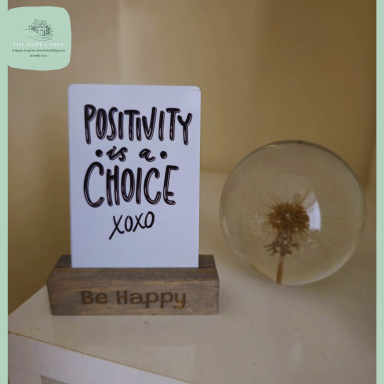 A personalised wooden place card holder with positive affirmations.
