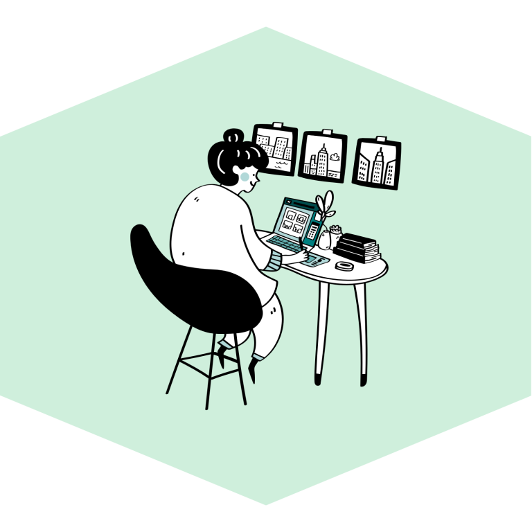 An image of a person working online at a desk. They are smiling.